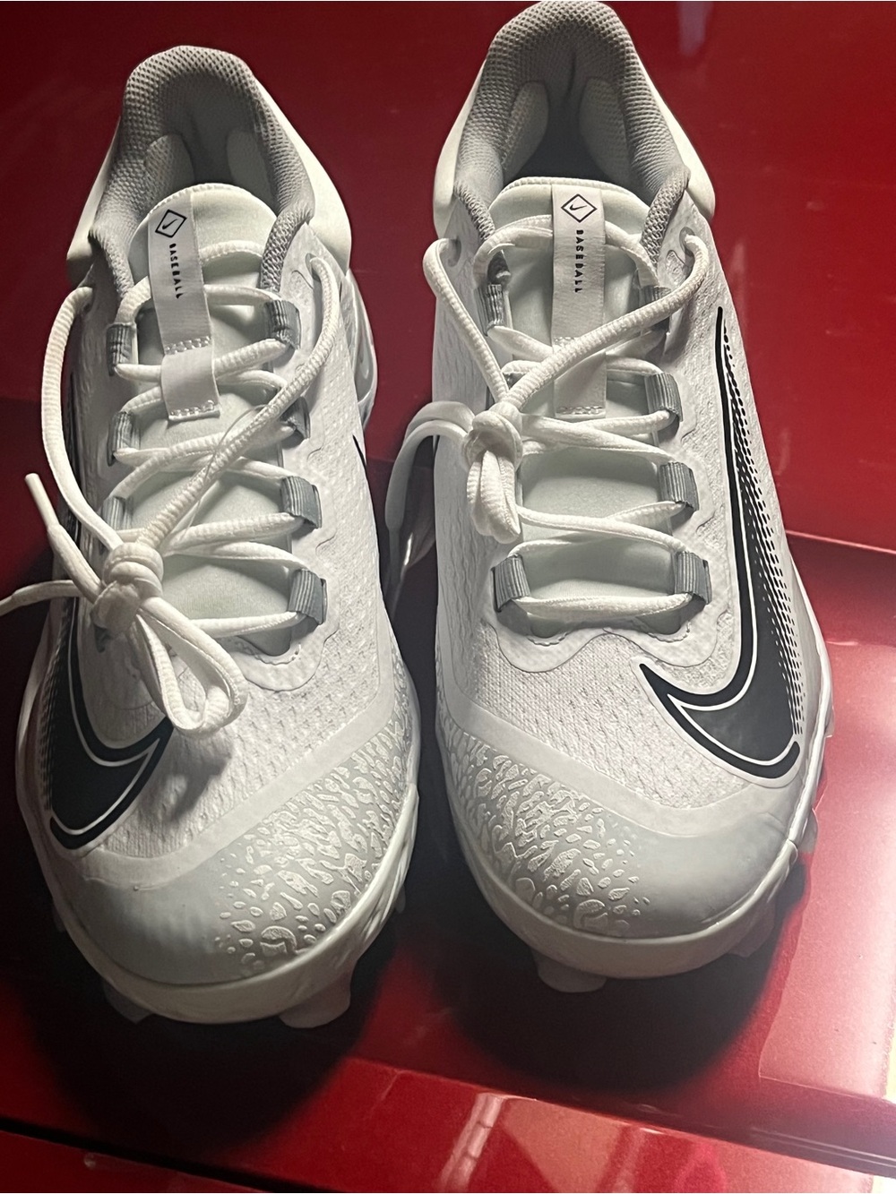 Nike White Athletic Cleats with Black Swoosh Accent